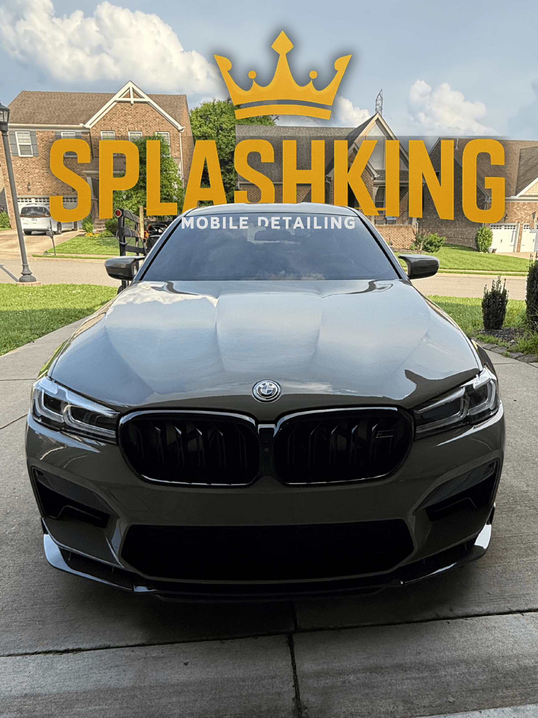 Glossy grey BMW front view with Splashking Mobile Detailing branding and a yellow crown.